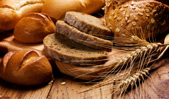 assortment of baked bread assortment of baked bread on wood table
